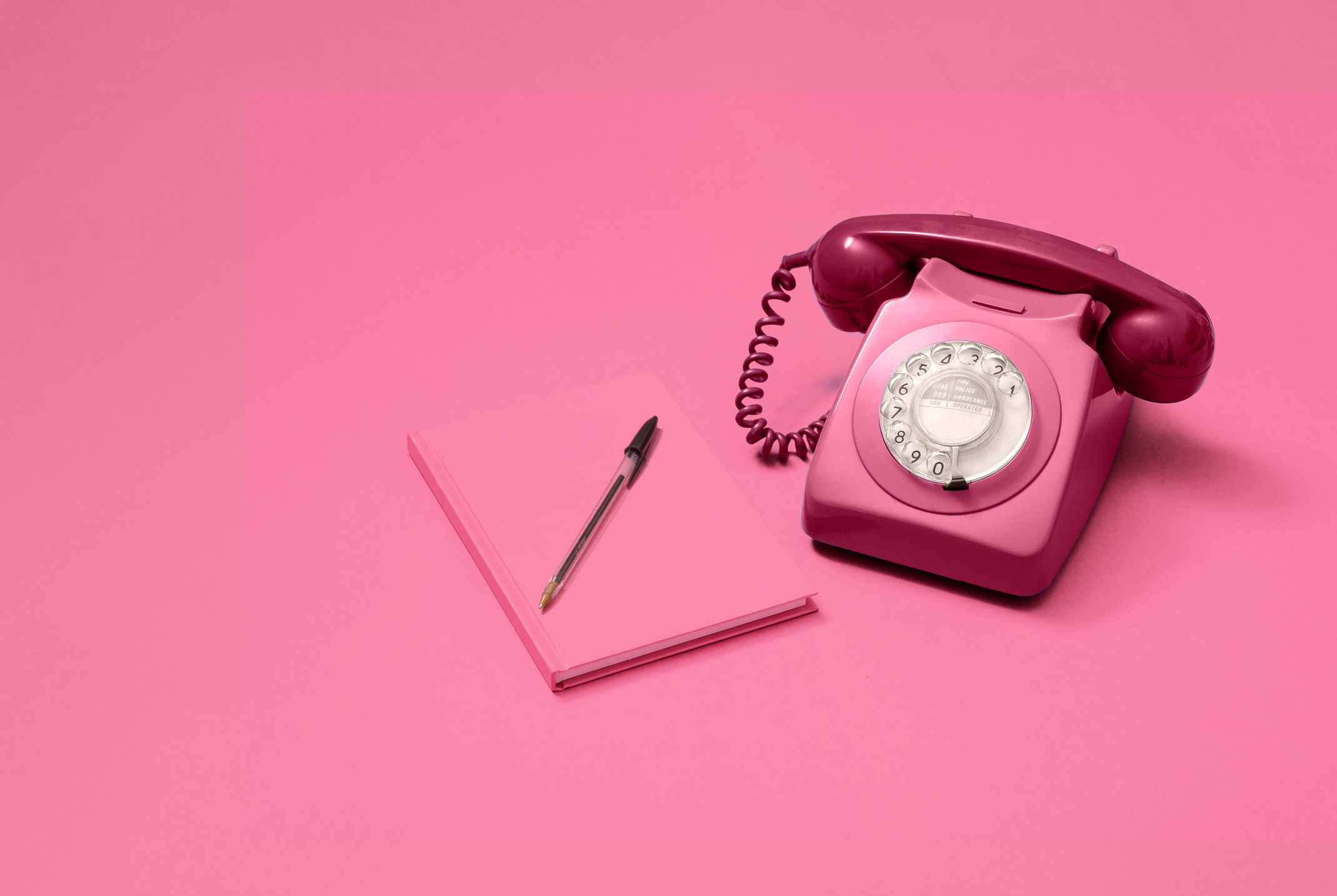 Pink rotary phone and pink notebook